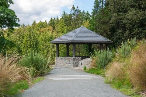 Arbor in shadow of the trees Stock Photos