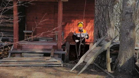 Arborist prepares to stretch the rope Stock Footage 97359695