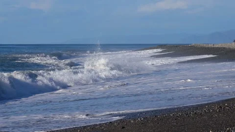 In arc beach in front of the eyes,Continuous rolling wave rush to the shore. 4K. Stock Footage 259691952