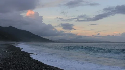 In arc beach at sunset,the continuous rolling wave,picturesque seascape. Stock Footage 277953232