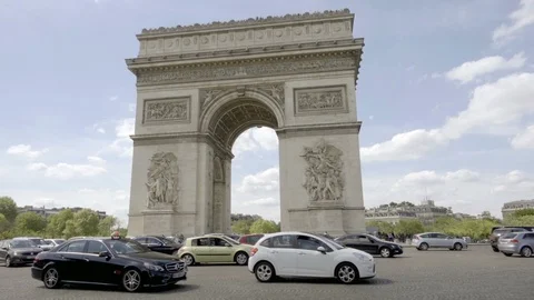 Arc de Triomphe on beautiful day cars driving around traffic circle Paris France Stock Footage 93810819