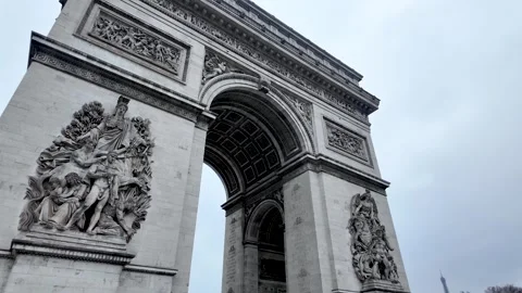 Arc de Triomphe dominating a cloudy Paris morning with detailed bas reliefs Stock Footage 330857479
