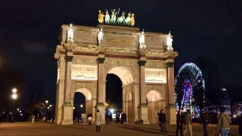Arc de Triomphe du Carrousel and ferris wheel at night in Paris, France Stock Footage 329478243