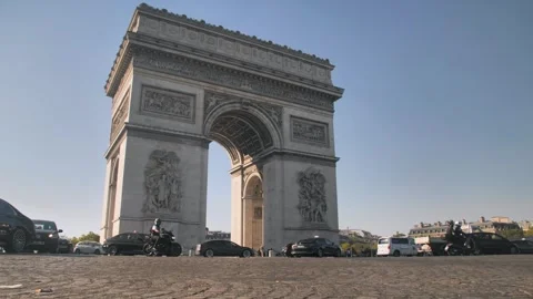 Arc de Triomphe is located in Paris in an autumn landscape. Road with many Stock Footage 253813976