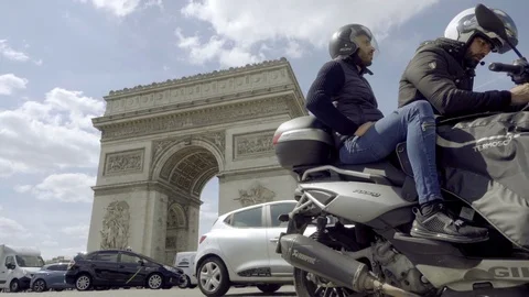 Arc de Triomphe men motorcycle parked while cars driving traffic Paris France Stock Footage 93811832