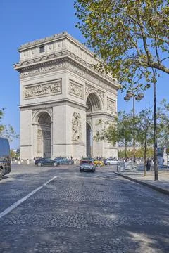 Arc de Triomphe monument in Paris with tourists under clear blue sky Stock-Fotos