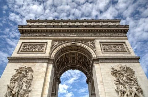 Arc de Triomphe in Paris The Arc de Triomphe in Paris against a blue sky C... Stock-Fotos
