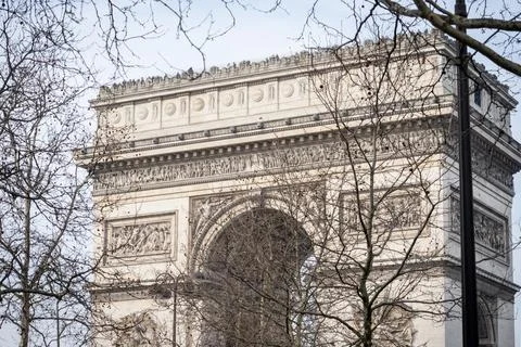 The Arc de Triomphe in Paris through the bare branches of trees in winter - 1 Stock Photos