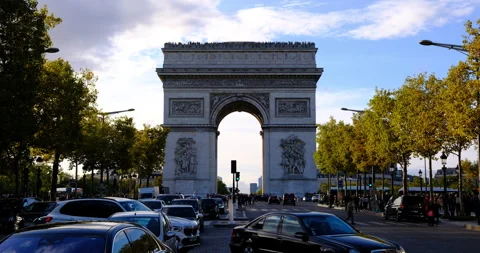 Arc de Triomphe in Paris under afternoon sunlight with traffic and pedestrians Stock Footage 329173778