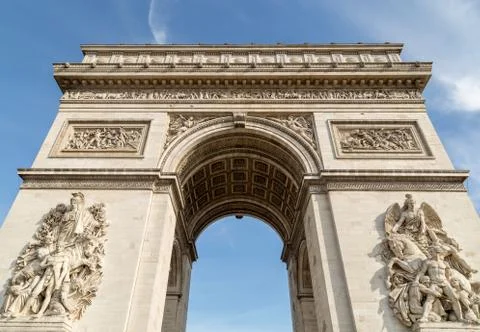 Arc de Triomphe in Paris under sky with clouds. One of symbols of France and one Stock Photos