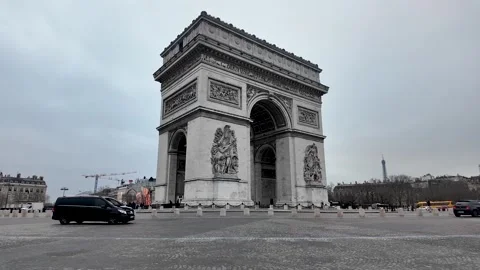 The Arc de Triomphe stands prominently in Paris France under an overcast sky Stock Footage 330859669