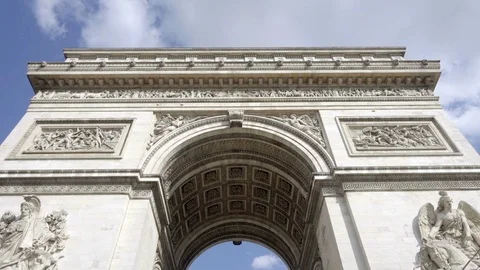Arc de Triomphe tilting down street underneath tourists walking Paris France Stock Footage 93811192