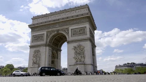 Arc de Triomphe traffic circle beautiful day low cobblestone street angle Paris Stock Footage 93811581