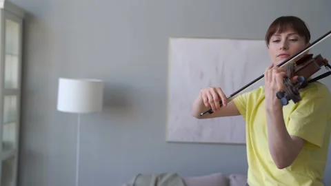 Arc Medium Shot Of Attractive Young Woman Skilfully Playing The Violin At Home. Stock Footage 155107877