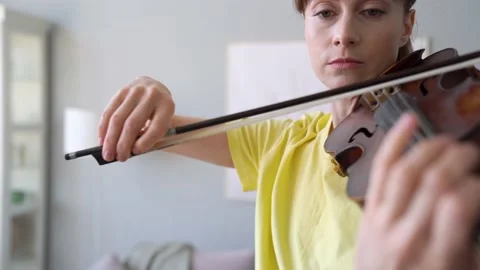 Arc shot Of Close-up Bow. Brunette Woman Is Practising Violin at Home. Stock Footage 155107743