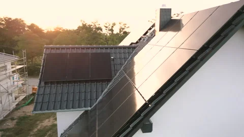 Arc shot of modern solar panels installed on the roof of a single-family house Video stock 252345575