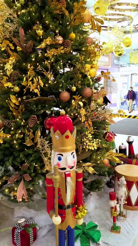 Arc Shot Nutcracker and Gifts Under Christmas Tree Inside Shopping Mall 4K 60fps Video stock 259579294