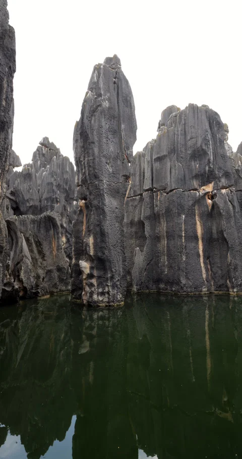 Arc vertical shot of impressive limestone pillars at Sword Peak Pond, Shi Lin Stock Footage 329597027
