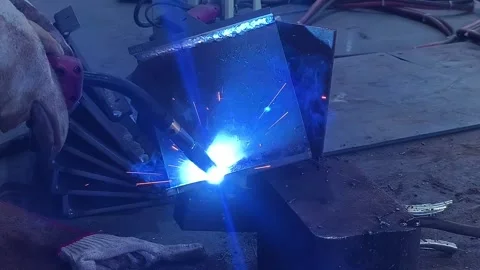Arc welding operation on thick metal workpiece with flying sparks Stock Footage 342272652