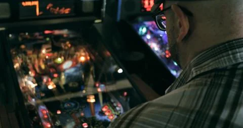 Arcade: Anonymous Man Playing Pinball Stock Photos