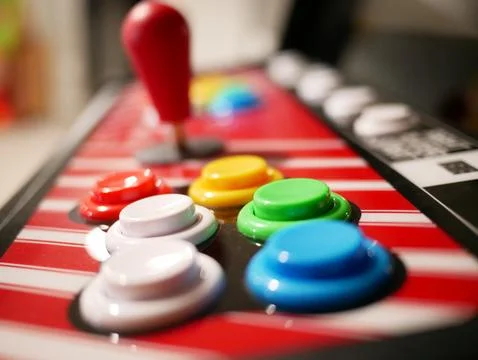 Arcade buttons with joystick in background Stock Photos