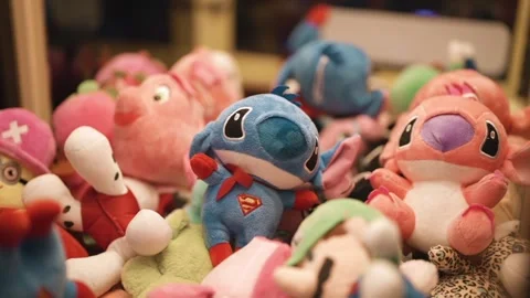 Arcade claw machine filled with colorful collection plush toys displayed Stock Footage 332089757
