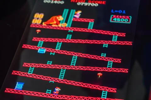 Arcade machine with Donkey Kong game, featuring pixelated 80s style graphic.. Stock Photos