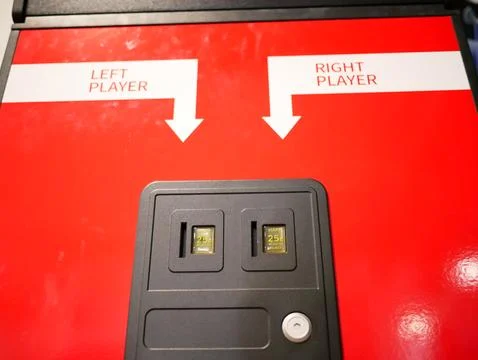Arcade machine with left player and right player quarter slots Stock Photos