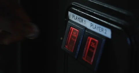 Arcade: Man Inserts Quarter Into Game Slot Stock Footage 107945172