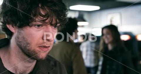 Arcade: Man Playing Pinball With People Behind Stock Photos