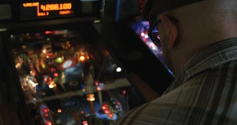 Arcade: Rear View Anonymous Hipster Playing Pinball Stock Footage 107945448