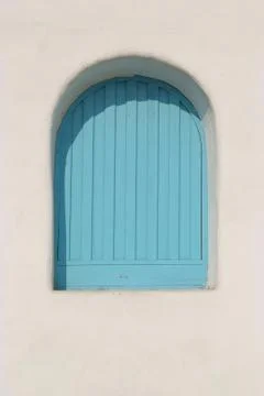 Arch blue  window on the white wall Stock Photos