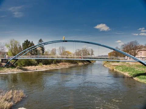 Arch bridge built over a river under a sunny blue sky 스톡 사진