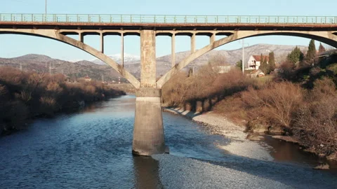 Arch bridge over the river - concrete  structure used for transportation, Stock Footage 232476268