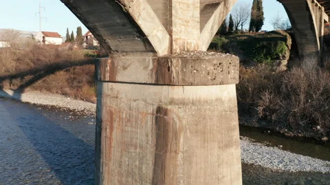 Arch bridge over the river - concrete  structure used in transportation spanning Stock Footage 232485106