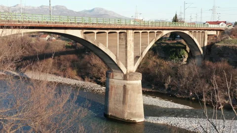 Arch bridge over the river - concrete  structure used in transportation spanning Stock Footage 232492843