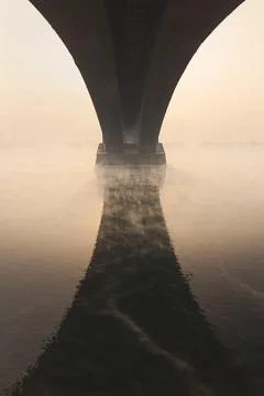 The arch of the bridge is reflected in the water, an architectural element of Stock Photos