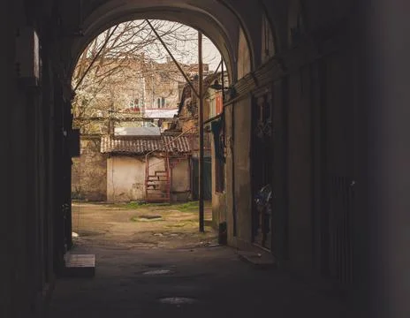 An arch to enter classic old yard in Odessa city center. Dilapidated houses,  Stock Photos