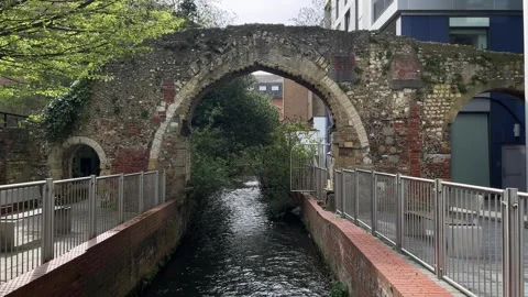 Arch Ruin Over Brook with Modern Offices – Static UK Urban Contrast Shot Video stock 332136491