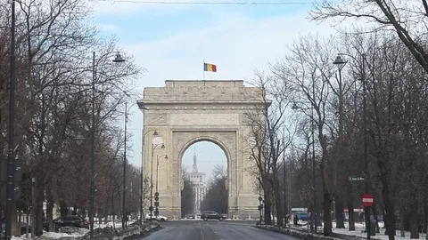 The Arch of Triumph (Arcul de Triumf) from Bucharest Romania with romanian fl Stock Footage 81068821