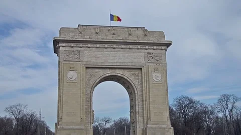 The Arch of Triumph (Arcul de Triumf) from Bucharest Romania with romanian fl Stock Footage 81068829