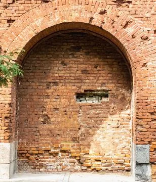 Arch in the wall made of old structural bricks. Textured background. Architec Foto stock