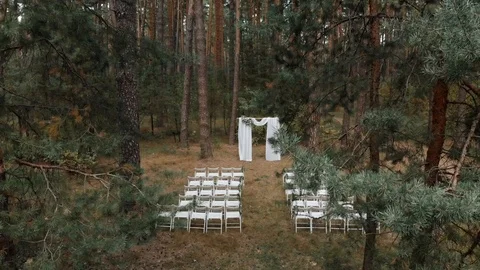 Arch for the wedding ceremony of burlap and wooden logs in pine forest. wedding  Stock Footage 107342893