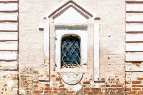 Arch window with white frame and grid in historical building Stock Photos