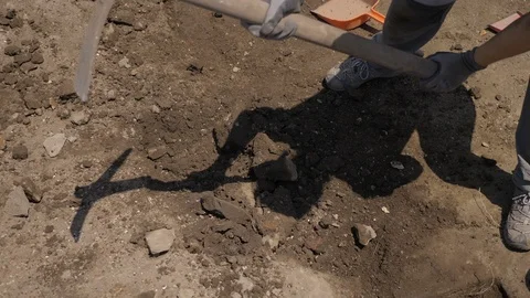 Archaeological excavations, archaeologist digs with the pickaxe Stock Footage 116399450