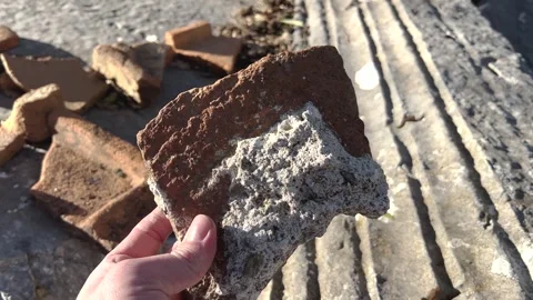 Archaeologist Hand holding ancient broken ceramic brick Video stock 330604544