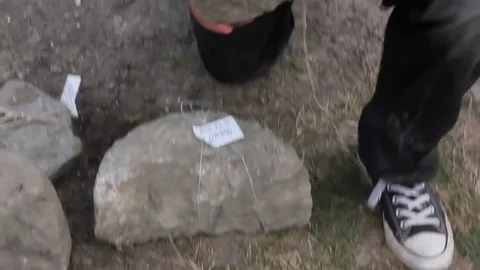 Archaeologist holding grinding stone 動画素材 70865388