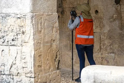 An archaeologist with instruments working in one of the ancient Mayan ruins. Stock Photos