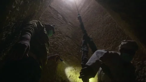 Archaeologists exploring and escaping an ancient underground tomb Stock Footage 336752278