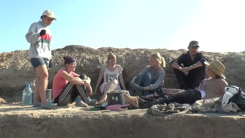 Archaeologists rest at the excavation site Stock Footage 104956784
